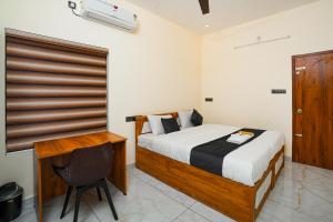 a bedroom with a bed and a chair in it at Uni Stay Inn in Cochin