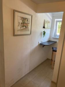 a room with a picture on the wall and a table at Appartement 1 in Wackersdorf