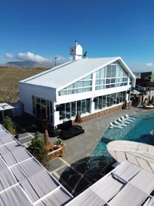 a large white building with a swimming pool next to it at O Sommet in Zaarour