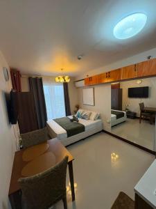 a bedroom with a bed and a table and a room at At LBS 888 Condo Unit Rental-Full Relaxing Seaview 304-10Flr in Lapu Lapu City