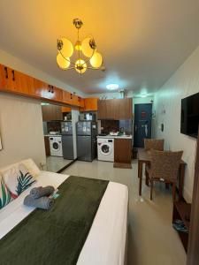 a bedroom with a large bed and a kitchen at At LBS 888 Condo Unit Rental-Full Relaxing Seaview 304-10Flr in Lapu Lapu City