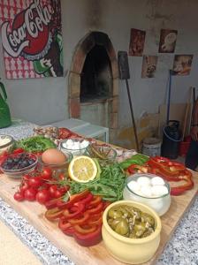 a table with vegetables and other foods on it at Villa Oliva Torotto in Niscemi