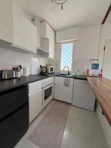 a kitchen with white appliances and a wooden counter top at Casa del Sol - Santiago de la Ribera, San Javier, 600 m from the beach, swimming pool in San Javier