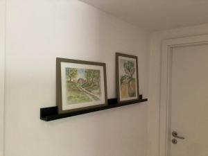 two framed pictures on a wall in a room at Appartement 1 in Wackersdorf