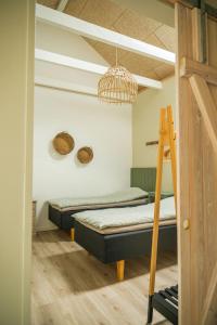 a room with two bunk beds and a ladder at Lustrup Farmhouse in Ribe