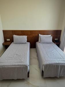 two beds sitting next to each other in a room at Hôtel Majestic Rabat Centre in Rabat +45 photos