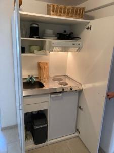 a small kitchen with a sink and a counter at Appartement 1 in Wackersdorf