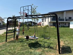 two girls playing basketball on a basketball hoop at Apartments Wally in Ptuj