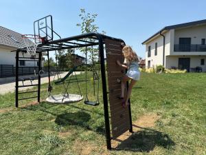 a young girl playing on a basketball hoop at Apartments Wally in Ptuj