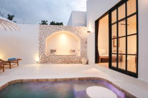 a house with a swimming pool and a fireplace at The Lost Island- Luxury Private Pool Villas in Gili Trawangan +163 photos