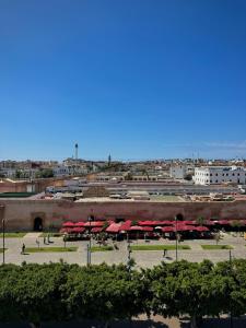 a park with red umbrellas in a city at Hôtel Majestic Rabat Centre in Rabat