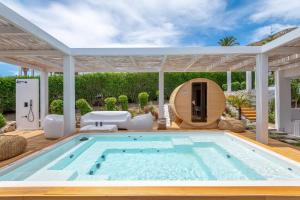a swimming pool in a house with a pergola at Dimitra Beach Hotel & Suites in Ágios Fokás