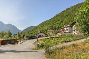 a winding road in a valley with a mountain at Locanda delle Miniere in Ollomont
