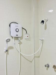 a shower with a white shower head and a shower at Viyona Guest House in Trincomalee +60 photos