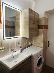 a bathroom with a sink and a washing machine at Casa Filita 'Old Town Traditional House' in Kos +29 photos