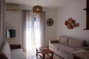 a living room with a couch and a table at Mahi Studios in Patitiri