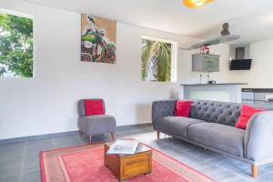 a living room with a couch and a chair at Villa Aquarium in Saint-François +19 photos