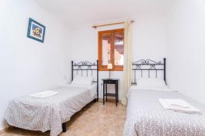 A bed or beds in a room at Villa César