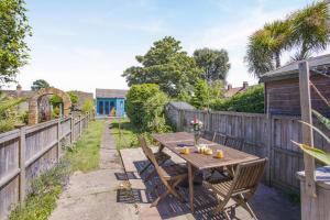 a wooden table and chairs in a garden at 4 Bed in Reydon oc-l30001 in Reydon