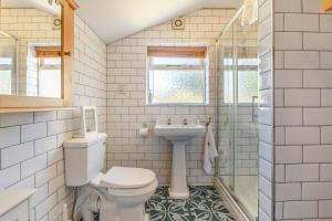 a bathroom with a toilet and a sink at 4 Bed in Reydon oc-l30001 in Reydon +19 photos
