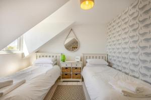 two beds in a room with white walls at 4 Bed in Reydon oc-l30001 in Reydon