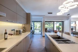 a kitchen with white cabinets and a counter top at Sea View Villa in most upscale Yalikavak in Bodrum City