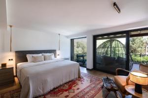 a bedroom with a large bed and a large window at Sea View Villa in most upscale Yalikavak in Bodrum City +32 photos