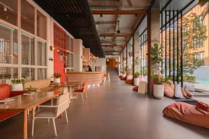 a restaurant with tables and chairs and potted plants at Craftsman Bangkok in Bangkok