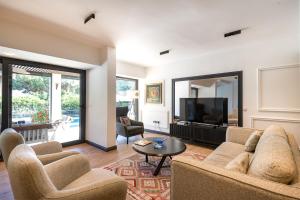 a living room with two couches and a television at Sea View Villa in most upscale Yalikavak in Bodrum City