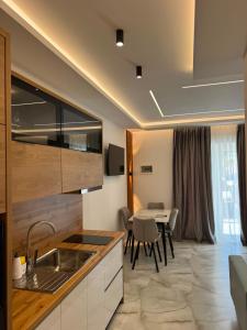 a kitchen and dining room with a table and chairs at Casa Palma Villa in Velipojë