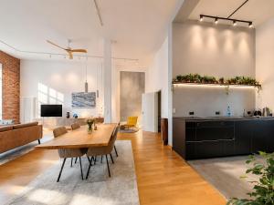 a kitchen and living room with a wooden table in a room at Schwarzwald Loft Baden-Baden in Baden-Baden