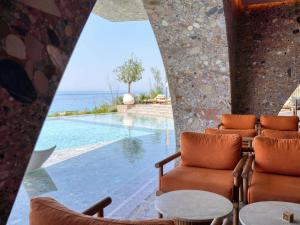 a room with a view of the pool and the ocean at Green Coast Hotel MGallery Collection in Vlorë