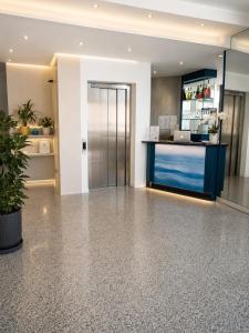 an office lobby with a reception desk and a door at Hotel Alb's in Alba Adriatica