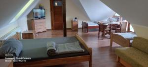 a living room with a couch and a dining room at Kaszubska Enklawa in Rytel