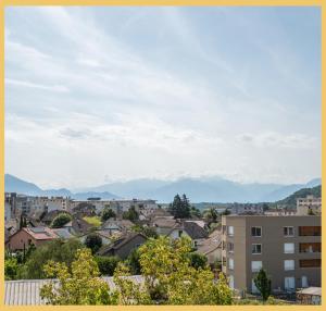 a view of a city with mountains in the background at Chez Gilles I Studio I Ambilly in Ambilly