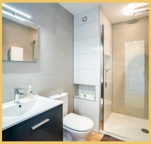 a bathroom with a toilet and a sink and a shower at Chez Gilles I Studio I Ambilly in Ambilly +9 photos