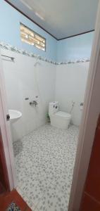 a white bathroom with a toilet and a sink at Ba Linh Homestay in Vĩnh Long +131 photos