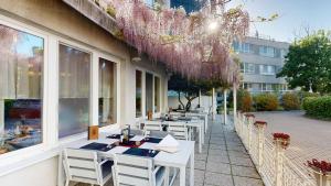a row of tables and chairs outside of a restaurant at Hotel SET in Bratislava