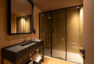 a bathroom with a sink and a shower at Breda Suites Hotel Milano in Milan
