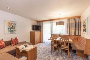 a living room with a couch and a table at Panorama Appartements in Längenfeld