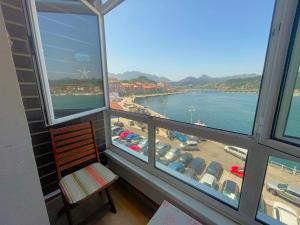 a room with windows with a view of a beach at El Pescador in Ribadesella