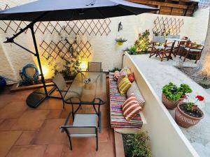 a patio with an umbrella and a table and chairs at Casa Filita 'Old Town Traditional House' in Kos