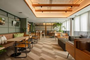 a restaurant with tables and chairs and a cafeteria at Craftsman Bangkok in Bangkok