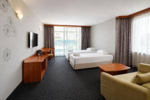 a hotel room with a bed and a couch at MPM Hotel Kalina Garden - All Inclusive in Sunny Beach +93 photos