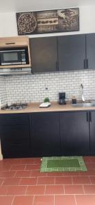 a kitchen with a counter top with a microwave at Sweet Sunset II- Rompeolas Beach in Aguadilla