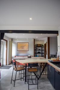 a kitchen and dining room with a table and chairs at L'atelier de Mathieu meublés de tourisme classés in Saint-Rémy-sur-Durolle