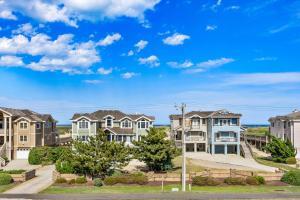 a row of houses with a blue sky at 6118 - Ferrari II in Nags Head