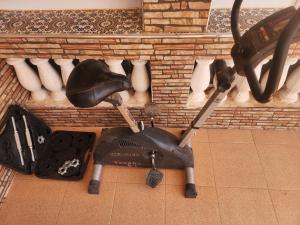 a scooter sitting on the floor next to a brick wall at Desert Stars Oasis in Aoufous
