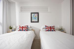 two beds sitting next to each other in a room at The Penthouse Fistral Beach, Newquay in Crantock