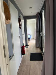 a hallway with a door leading to a living room at Luxus Chalet Visarend 13 Strandkristall in Hulshorst